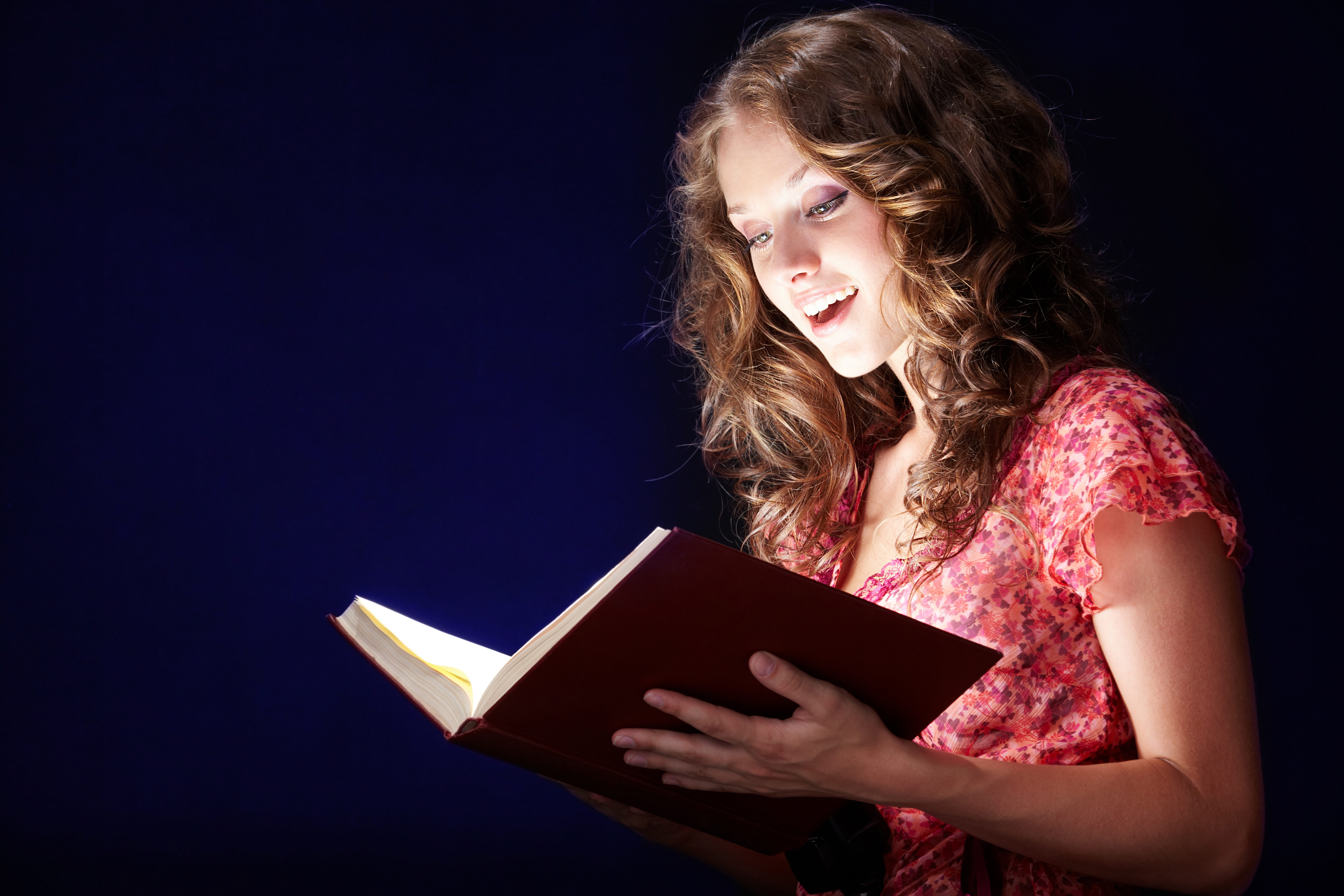 woman reading glowing book
