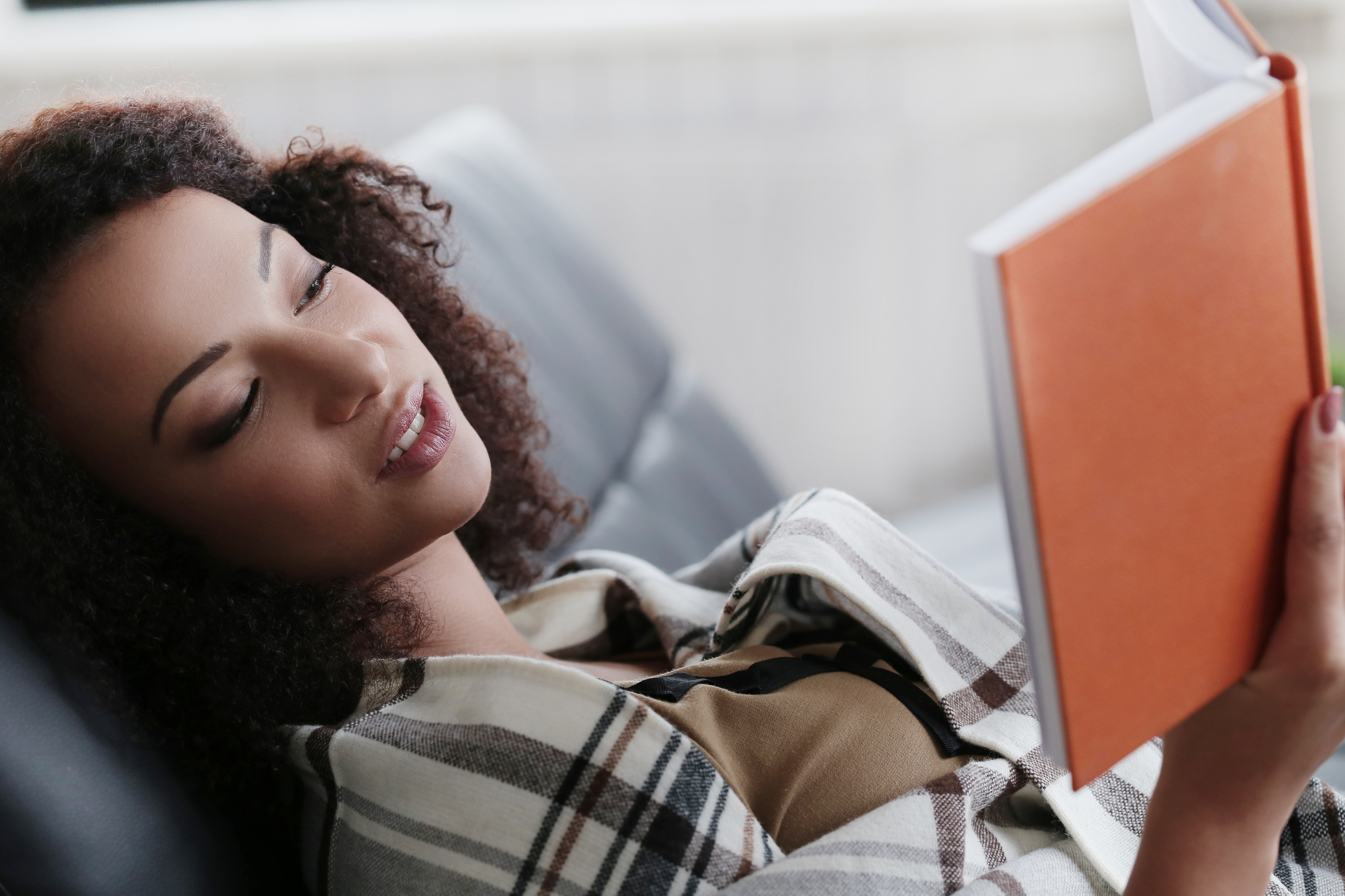 reclining woman reading book